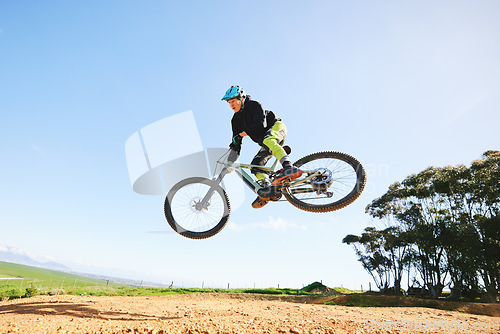 Image of Mountain bike, man and jump in blue sky for action, stunt performance and speed on mockup space. Bicycle, sports athlete and courage in air for freedom, risk or race in cycling competition with power