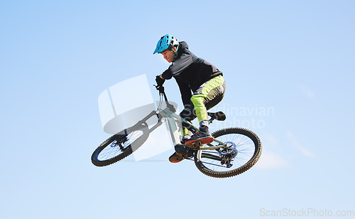 Image of Bicycle, man and jump in blue sky for competition, freedom and adventure with mockup space. Athlete, sports and bike in air for action, cardio race and courage for stunt performance, power or contest