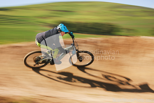 Image of Bicycle, man and cycling in motion blur on dirt path for competition, fast power and off road adventure. Athlete, sports and mountain bike for action, cardio race and speed in performance contest