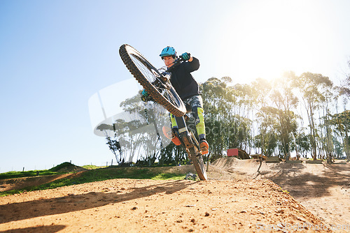 Image of Bicycle, wheelie and man with ramp, outdoor and speed for sport, race or adventure in summer, fitness or nature. Extreme cycling, person and jump for trail, exercise or challenge for workout in dirt