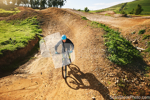 Image of Cycling, sports and man in nature on bicycle for adrenaline on adventure, freedom and speed. Mountain bike, countryside and cyclist for training, exercise and fitness on dirt road, trail and track