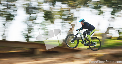 Image of Bicycle, man and speed with motion blur in forest for sport, race or adventure in summer, woods or nature. Extreme fast cycling, person and action on trail, workout or challenge for fitness on bike