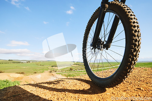 Image of Cycling, sports and closeup of wheel on bicycle for adrenaline on adventure, freedom and speed. Mountain bike, nature view and cyclist for training, exercise and fitness on dirt road, trail or track