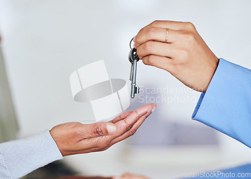 Image of People, hands and realtor giving keys to new home for mortgage loan, property sale or investment. Closeup of woman customer and real estate agent for house payment, purchase or agreement in deal