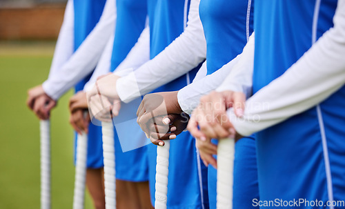 Image of Teamwork, sports and hockey with hands of people on field for workout, challenge and support. Fitness, competition and training with closeup of women at tournament for health, community and exercise