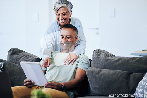 Image of Senior couple, tablet and point on sofa with smile, comic laugh or watch funny video on internet in home. Mature man, elderly woman and digital touchscreen with choice, shopping or social network app