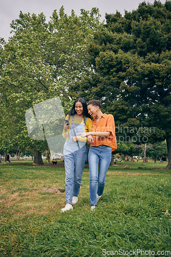 Image of Women, park and girl friends with phone outdoor with laughing at meme and social media. Urban, city garden and mobile with gen z, young and female people on holiday with freedom and happy in spring