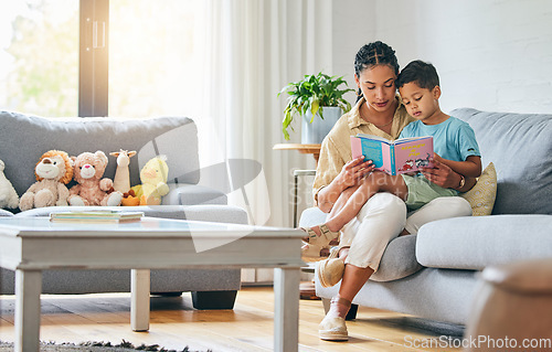 Image of Learning, book and mother with boy on a sofa for education, growth and child development in their home. Reading, love and mom with kid in living room for storytelling, literacy and communication