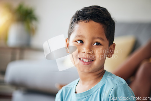 Image of Kid, smile and happy in family home in the morning with thinking feeling relax in living room. Lens flare, face and house with young child, boy and cute son from Brazil on weekend with joy and youth