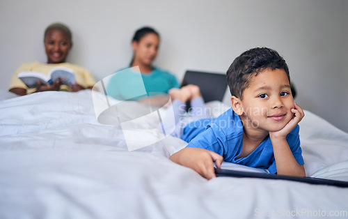 Image of Kid, tablet and happy portrait in bed at family home in the morning with lgbt parents feeling relax. Bedroom, education app and house with a young child smile online with mother and kids website