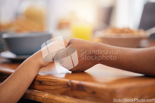 Image of Holding hands, prayer and dinner table with gratitude at family lunch with food and worship. Thanksgiving, holiday and dining room of people together at home for religion in a house with care to pray