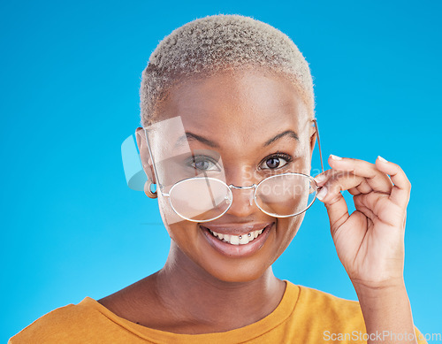 Image of Happy, portrait and black woman with glasses on a blue background for stylish, trendy and fashion. Cool, smile and headshot of an African girl or optometry model with eyewear for vision and eye care