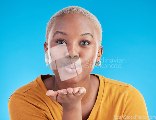 Image of Blowing kiss, blue background and portrait of black woman with emoji for affection, flirt and love. Happy, beauty and face of female person with hand sign for romance, confidence and relax in studio