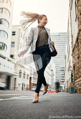 Image of Business woman, walking and job commute with trendy, gen z and young employee in the city. Busy, creative job and happy female professional on a sidewalk, street and urban road for travel to work