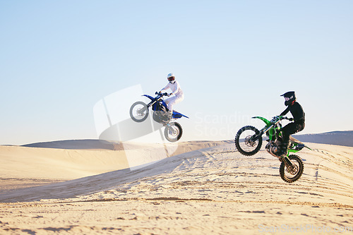 Image of Motorcycle, desert and jump in air, speed and competition at outdoor race for performance, goal or off road. Motorbike athlete, dune and ramp in nature, sand or together for training in mockup space