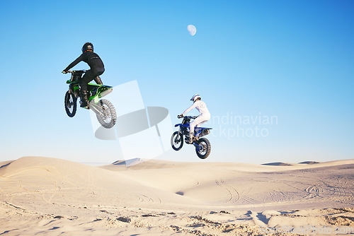Image of Motorcycle, desert and jump in sky, speed and competition at outdoor race for performance, goal or off road. Motorbike athlete, dune and ramp in nature, sand or together for training in mockup space