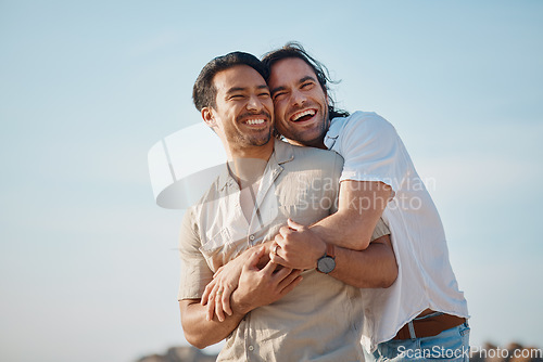 Image of Love, hug and gay men with blue sky, embrace and smile on summer vacation together in Thailand. Sunshine, romance and marriage, happy lgbt couple relax in nature on island holiday with pride and fun.