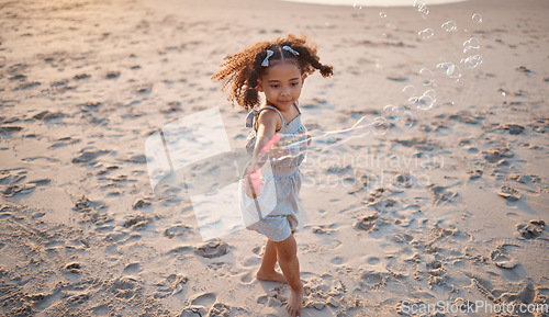 Image of Girl kid, beach and outdoor with bubbles, playing and freedom with air, games and smile in nature. Young female child, soap and water with plastic toys in wind, summer sunshine and happy on vacation