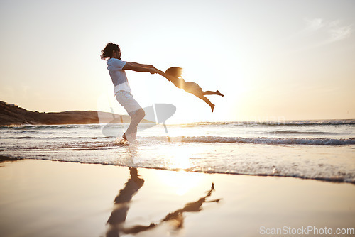 Image of Father, spin girl kid and beach with games, holding hands or sunset for bonding together by waves. Dad, female kid and swing for love, care or play by sea, silhouette or family on vacation in summer