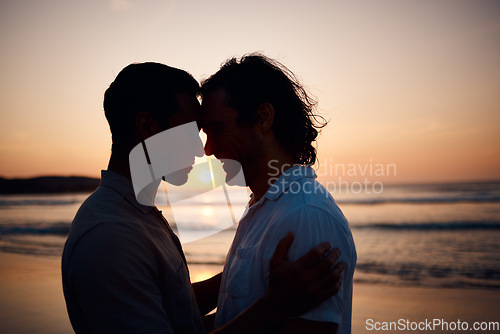 Image of Sunset, embrace and gay men on beach, silhouette and love on summer vacation together in Thailand. Sunshine, ocean and romance, lgbt couple hug in nature and fun holiday with pride, sea and waves.