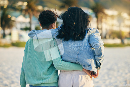 Image of Beach, lesbian or back of gay couple walking with love, care and pride in LGBTQ community with support. Hugging, queer women or people in nature on romantic date or commitment on holiday vacation