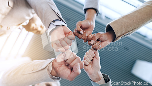 Image of Support, teamwork or business people fist bump in huddle for motivation, group mission or collaboration. Team building, low angle or hands of colleagues in meeting with goals, vision or solidarity