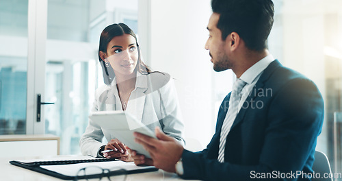 Image of Tablet, meeting and partnership with business people working in an office as a team for research. Technology, planning or teamwork with a man and woman employee reading information in the workplace