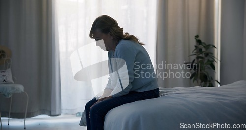 Image of Crying, depression and sad woman in bedroom with anxiety, mental health problem or debt in retirement. Lonely, worried and frustrated senior female person at home with headache, fatigue or bad crisis