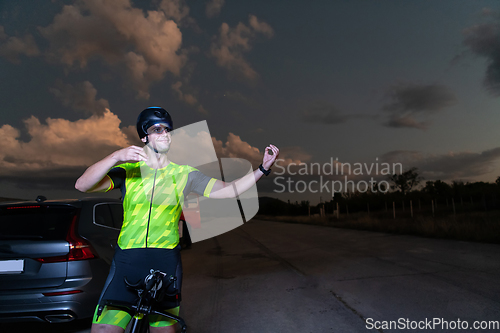 Image of Triathlete in professional gear running early in the morning, preparing for a marathon, dedication to sport and readiness to take on the challenges of a marathon.