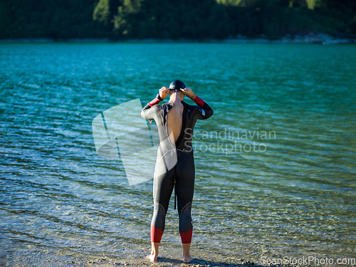 Image of A triathlon swimmer preparing for a river training to gear up for a marathon