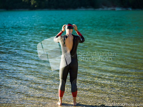 Image of A triathlon swimmer preparing for a river training to gear up for a marathon