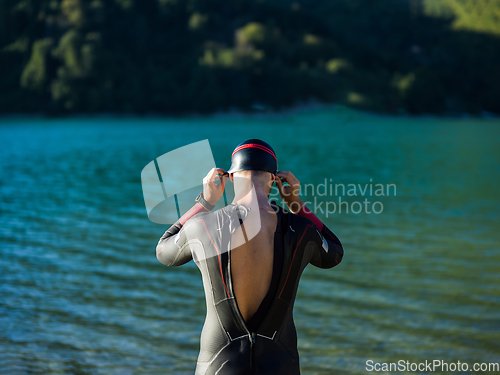 Image of A triathlon swimmer preparing for a river training to gear up for a marathon