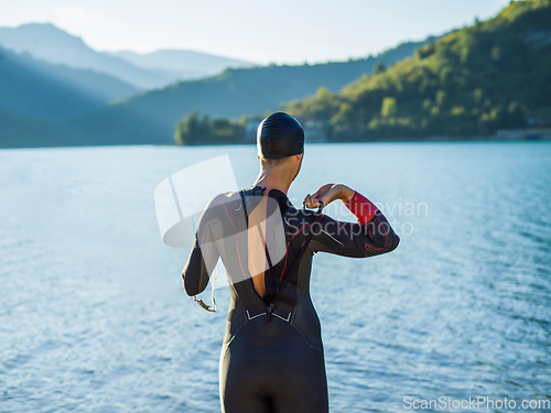 Image of A triathlon swimmer preparing for a river training to gear up for a marathon