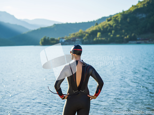 Image of A triathlon swimmer preparing for a river training to gear up for a marathon