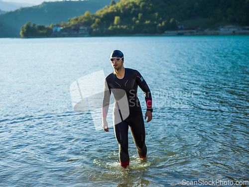 Image of A triathlon swimmer preparing for a river training to gear up for a marathon