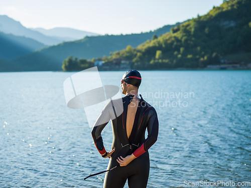 Image of A triathlon swimmer preparing for a river training to gear up for a marathon