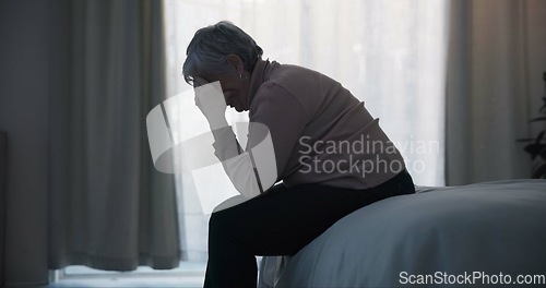 Image of Stress, depression and sad old woman in bedroom with anxiety, mental health problem and debt in retirement. Lonely senior female person crying at home for headache, pain and fatigue of crisis in mind