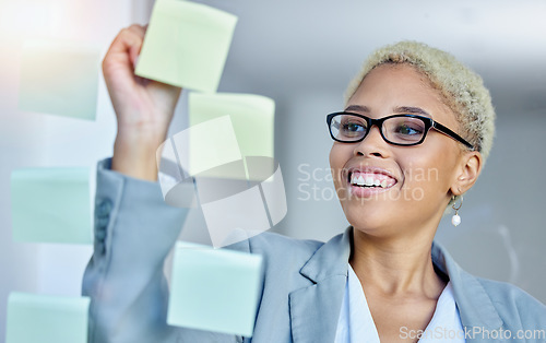 Image of Writing, planning and happy business woman in office with sticky note goal, idea or strategy. Schedule, smile and happy female manager brainstorming calendar, mission or agenda, management or growth