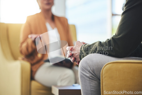 Image of Man, hands and listening for therapy, sofa or advice from woman for mental health, psychology or care. Psychiatrist, patient and frustrated in clinic, session or couch for help, anxiety or depression