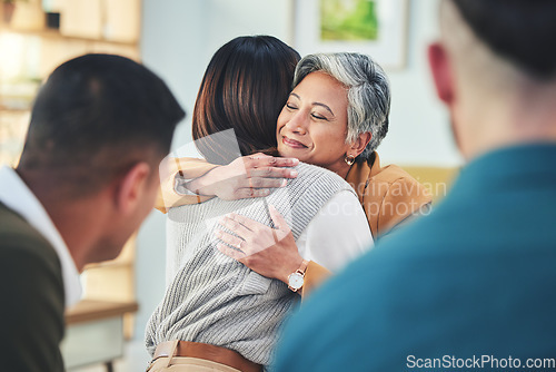 Image of Business people, women and hug in group therapy with smile, care and bonding for mental health in workplace. Corporate men, staff and colleagues with embrace for team building, love or thank you