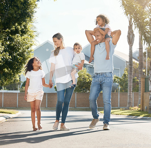 Image of Happy family, parents walking or children on road in neighborhood with support, care or love. Piggyback, interracial or dad on street to enjoy bonding together in nature with mom, kids or siblings