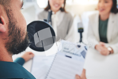 Image of Man, radio presenter and documents on microphone, reading or interview women for finance advice on show. Podcast, recording and business people speech with paperwork, script or information in studio