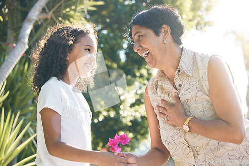 Image of Flower gift, child or grandmother in park bonding together on mothers day with care, love or support. Kid, family or girl holding hands or giving a happy mature woman a floral present in retirement