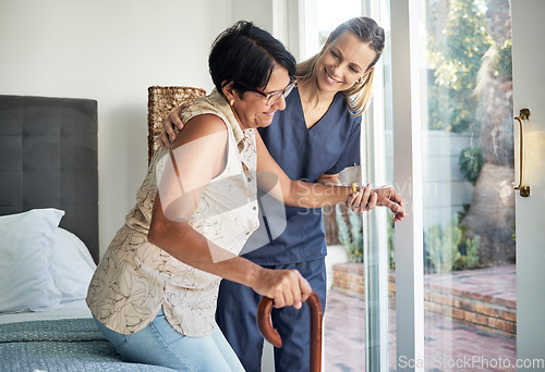 Image of Happy woman, nurse and senior in elderly care, support or walking with stick at old age home. Medical caregiver or therapist helping patient or person with a disability in retirement or physiotherapy