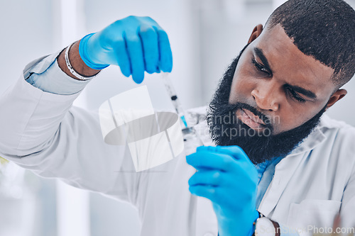 Image of Research, black man and vial with a needle, medical and experiment for healthcare, breakthrough and vaccine. Person, scientist and research with a syringe, cure and treatment with vaccination expert