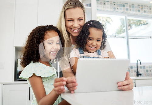 Image of Blended family, adoption and a mother with her children on a tablet in the kitchen for education or learning. Children, diversity and study with woman teaching her girl kids in their home together