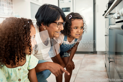 Image of Baking, oven and a senior woman with her grandchildren in the kitchen of a home together for cooking. Family, children and an elderly grandmother with female kids in the house for learning or growth