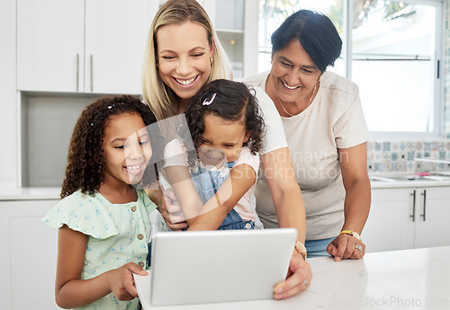 Image of Blended family, adoption and a girl with her mother on a tablet in the kitchen for education or learning. Children, diversity or study with a parent and granny teaching girl kids at home together