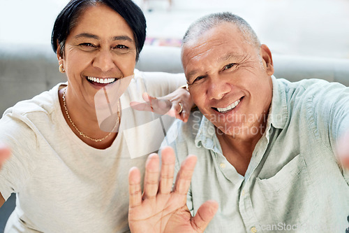 Image of Mature couple, waving and selfie on home sofa for video call, streaming and internet. A happy man and woman together on a couch for social media profile picture, hello or memory of healthy marriage