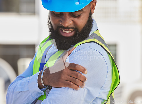 Image of Black man, engineer or hand on shoulder pain, injury accident or muscle tension on rooftop. Hurt, stress or injured male contractor with sore arm, ache and joint inflammation at construction site